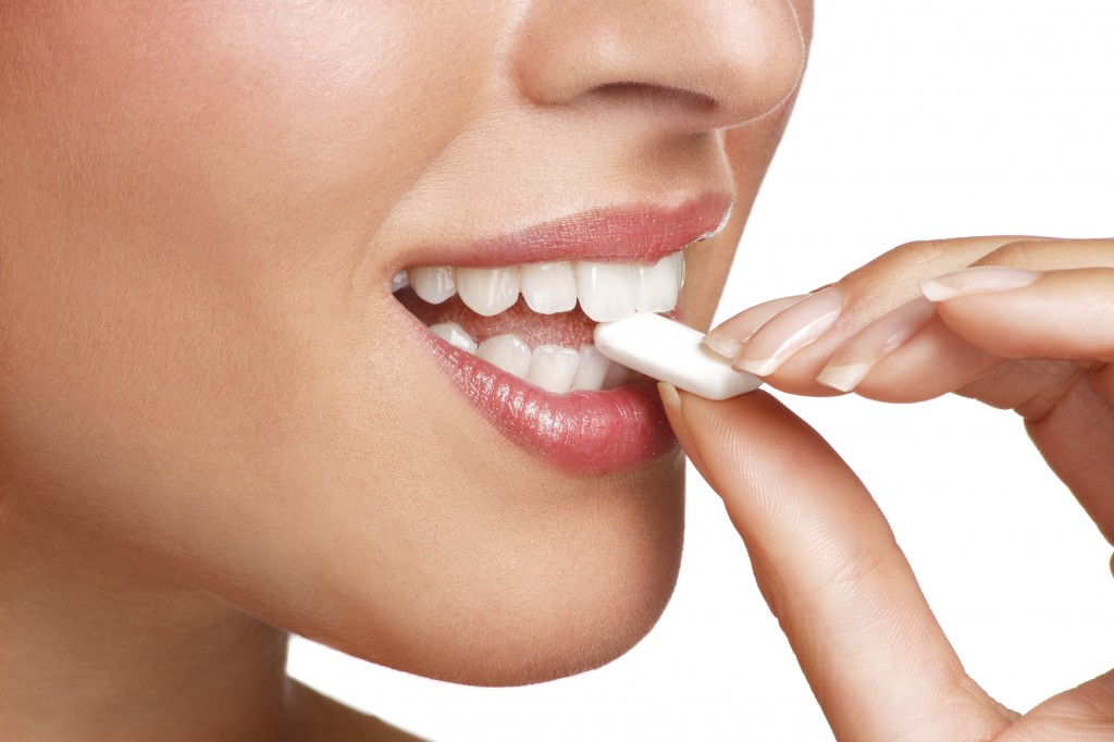 close up on a beautiful girl while enjoying a candy on white