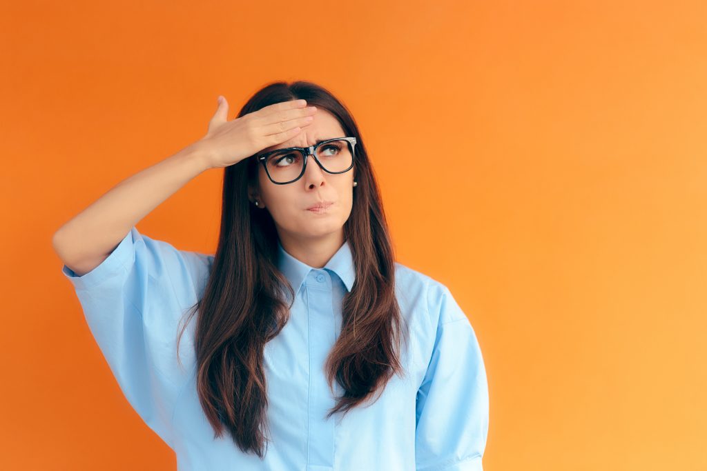 a confused and concerned young woman with glasses