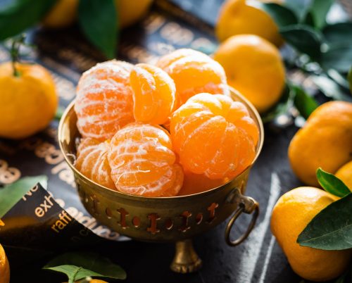 a bowl filled with peeled clementines